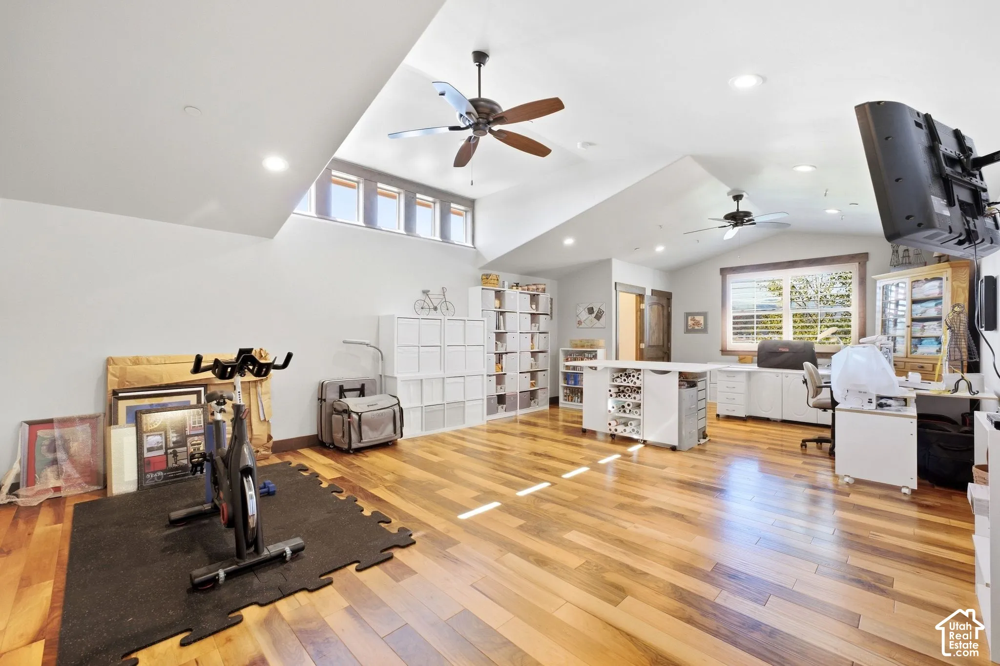 Vaulted ceilings, wood-finish flooring, recessed lighting, ceiling fans, and clerestory windows