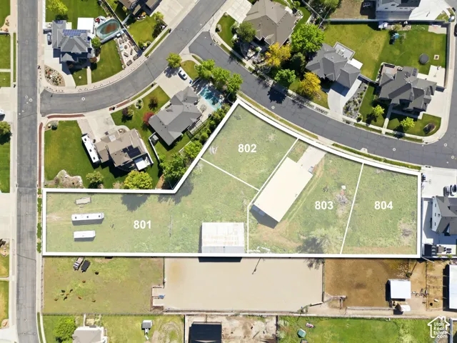 Expansive multi-parcel lot configuration featuring dedicated access points, open terrain, and existing secondary structures