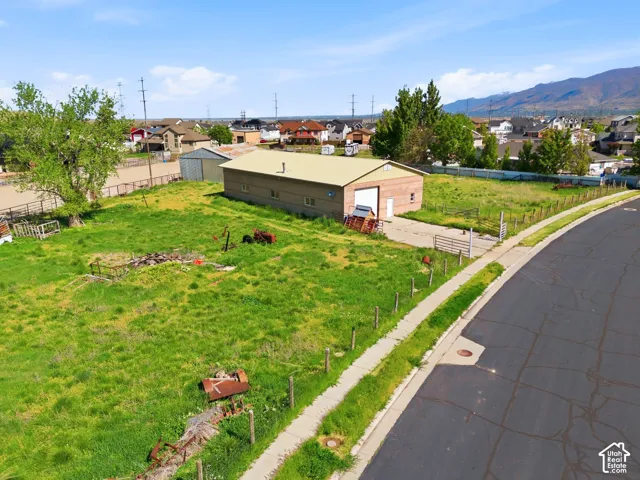 Expansive lot featuring a detached workshop, concrete driveway,