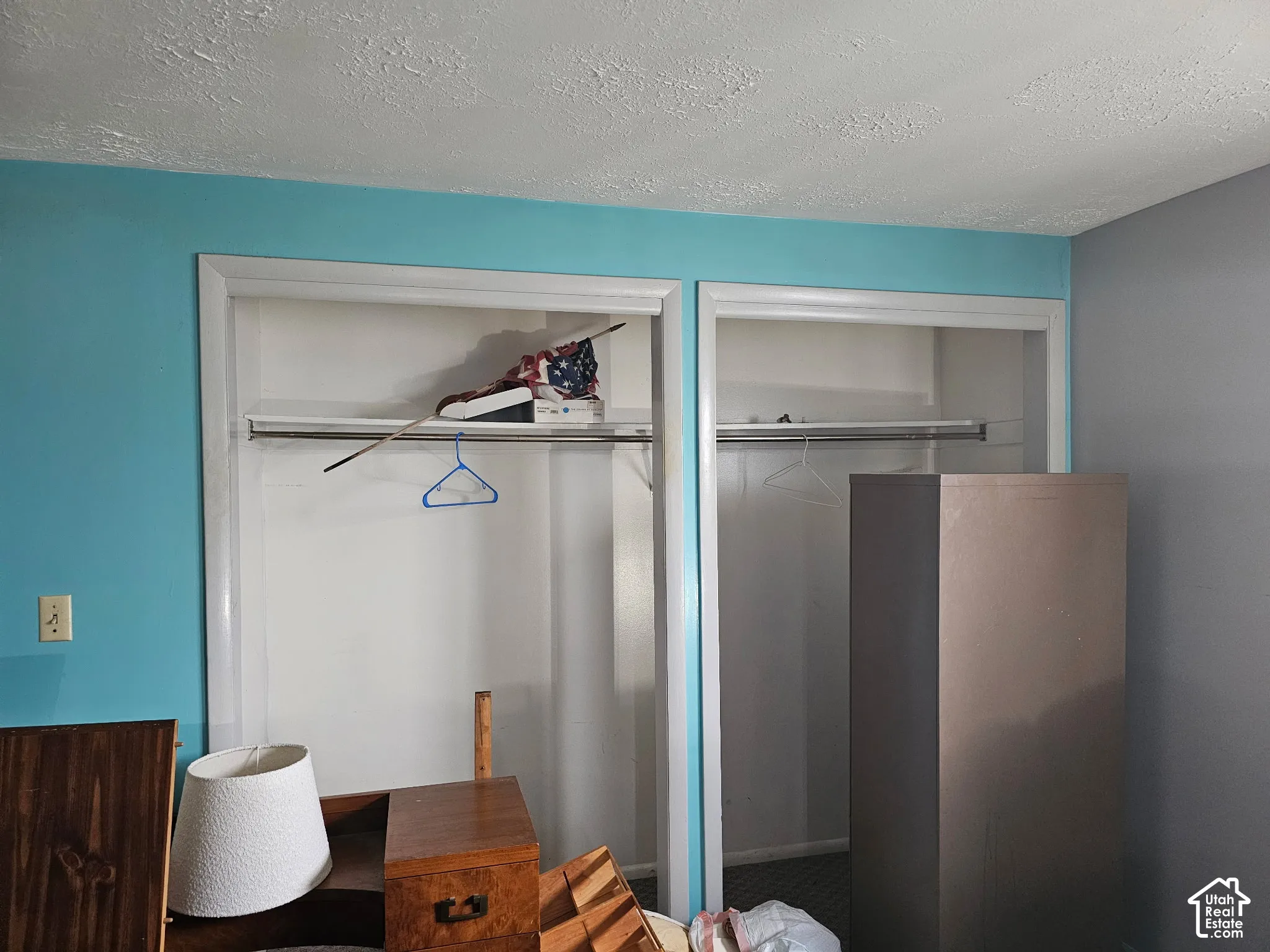 Dual reach-in closets featuring white trim and integrated metal hanging rods
