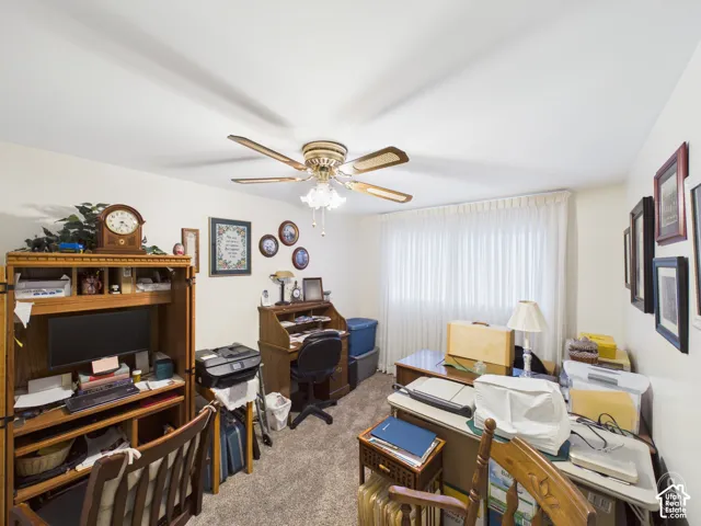 Interior room featuring wall-to-wall carpeting and a ceiling fan with integrated lighting