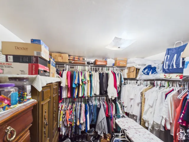 Walk-in closet featuring tiered wire shelving and a square flush-mount ceiling fixture