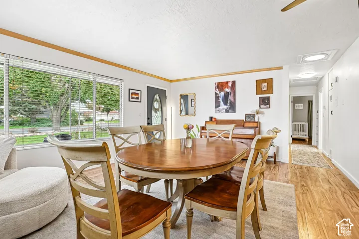 Interior featuring wood-finish flooring, a large picture window, and a recessed ceiling light