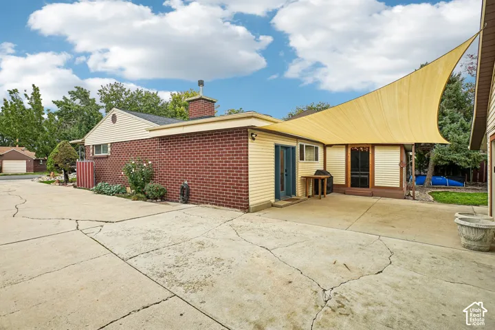 Exterior space featuring a brick and vinyl siding fa