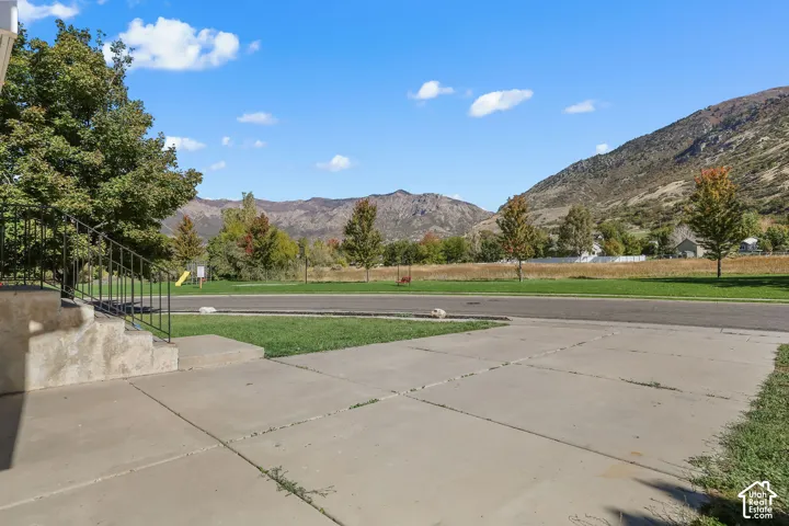Concrete patio area with metal railings and expansive mountain backdrop