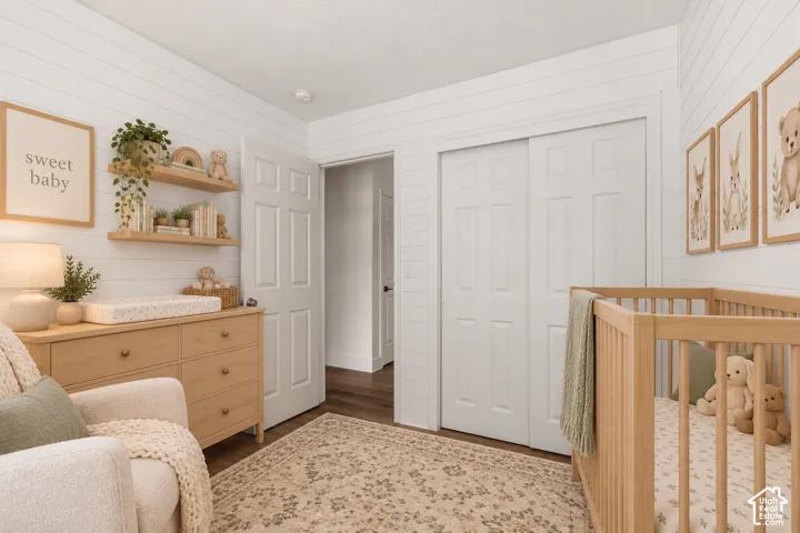 Horizontal plank wall paneling, dual built-in wall shelves, wood-finish flooring, and six-panel interior doors