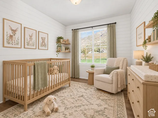 Horizontal plank wall detailing, wood-finish flooring, built-in wall shelving, and large window with mountain backdrop