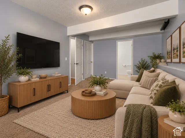 Neutral-toned carpeted interior space featuring structural soffit detail, flush-mount lighting, and multi-panel doors