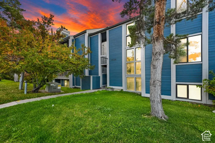 Multi-story exterior featuring blue siding, vertical accent trim, and expansive multi-pane window configurations