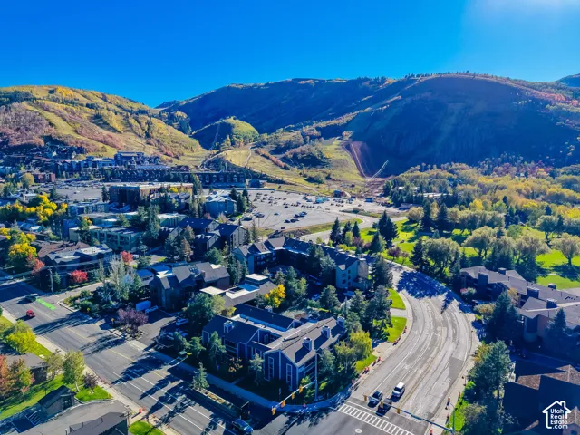 Aerial perspective featuring mountain terrain, surrounding evergreen trees, and proximity to regional infrastructure