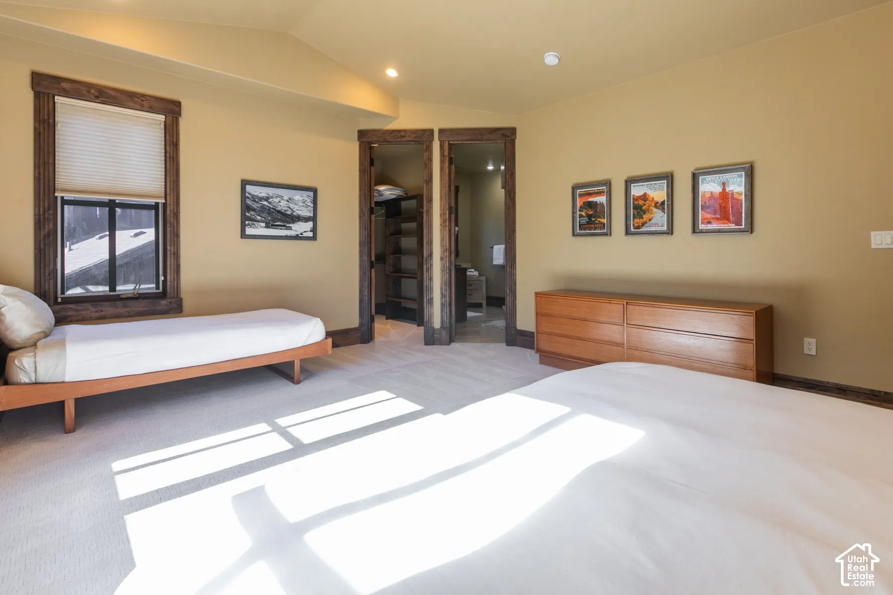 Vaulted ceiling, rustic stained-wood door and window casings, and built-in closet shelving