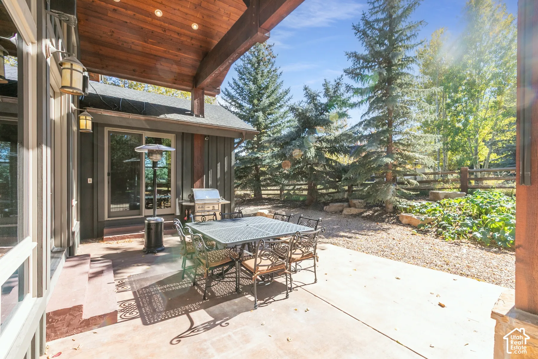 Covered patio featuring a wood-plank ceiling, recessed lighting, concrete flooring, and vertical wood siding
