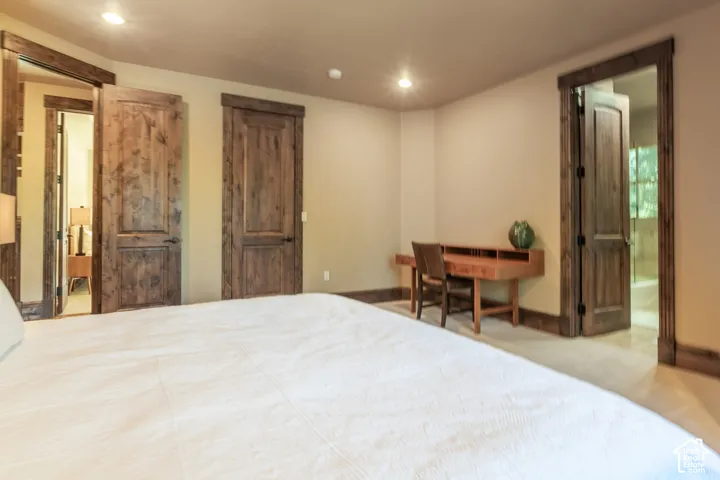 Room featuring stained wood interior doors, heavy wood trim, recessed lighting, and wall-to-wall carpeting
