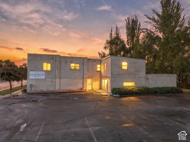 Commercial exterior featuring a multi-level masonry facade, paved asphalt parking area, and established perimeter landscaping
