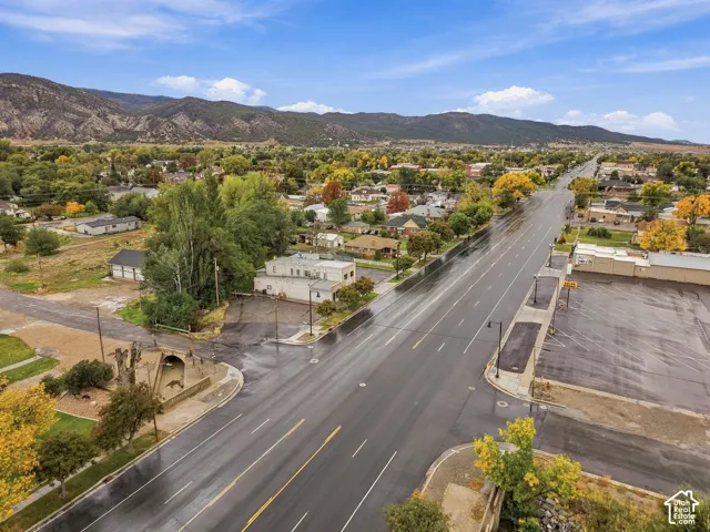 Aerial perspective featuring expansive mountain topography and mature deciduous trees