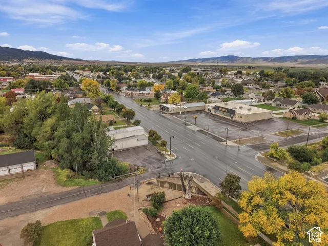 Aerial perspective highlighting the surrounding neighborhood infrastructure and prominent mountain range backdrop
