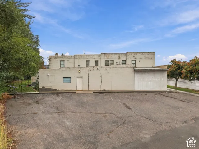 Multi-level masonry exterior with an attached paved parking lot