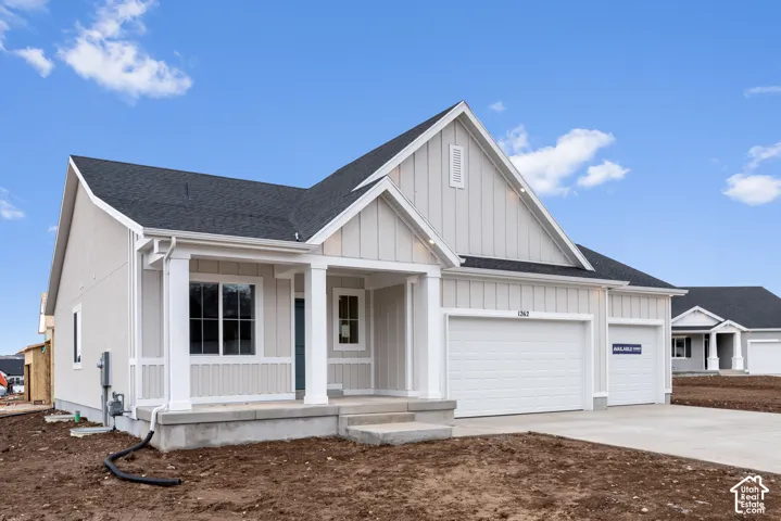 Exterior featuring board and batten siding, a covered front porch with square columns, and a three-car garage