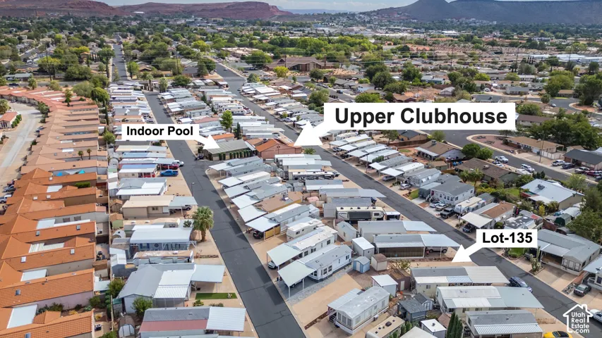 Aerial perspective featuring proximity to a community clubhouse and an indoor swimming facility, set against a mountainous landscape