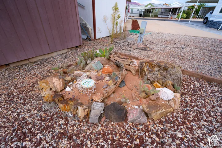 Low-maintenance xeriscaped garden bed featuring natural rock borders, desert flora, and decorative stone mulch