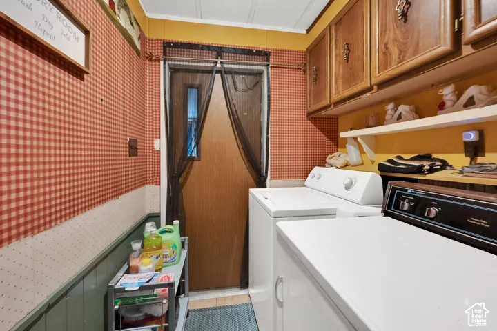 Utility space featuring wood-finish upper cabinetry, open shelving, and exterior access door