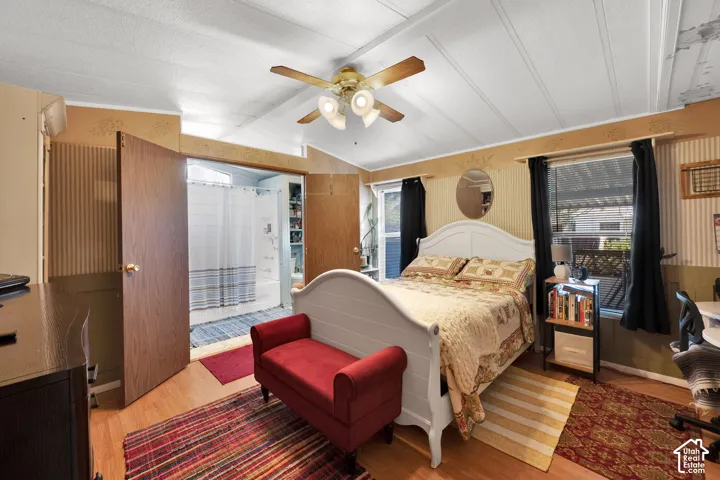 Wood-finish flooring, ceiling fan with integrated lighting, and dual windows