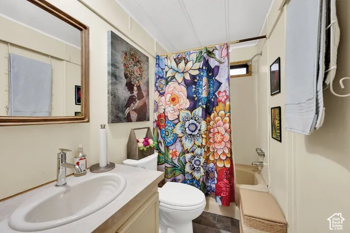 Bathroom featuring a vanity with an integrated basin, single-handle faucet, framed wall mirror, and a tub-shower combination with a showerhead and faucet
