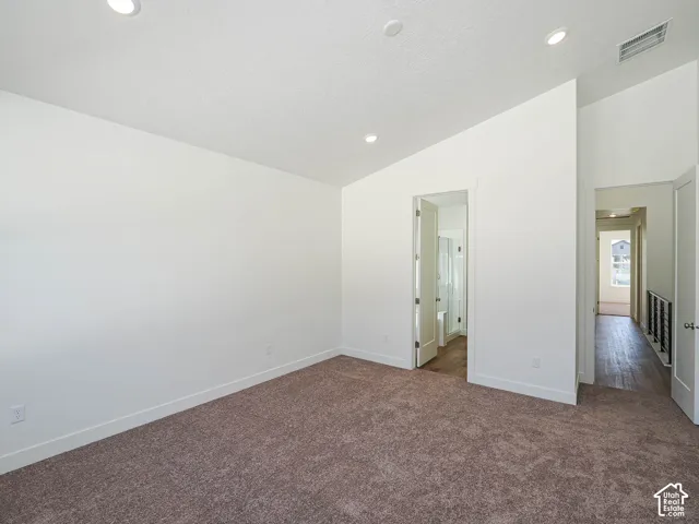 Vaulted ceilings, neutral wall finishes, recessed lighting, and carpeted flooring