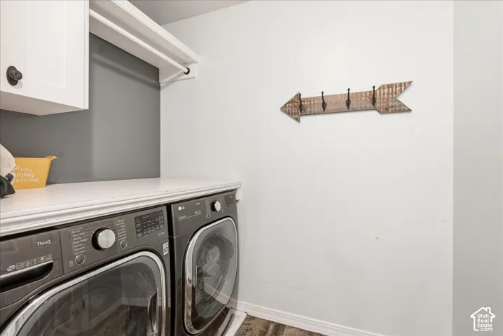 Laundry area featuring white shaker-style wall cabinetry, a continuous white laminate countertop, and integrated overhead storage shelving
