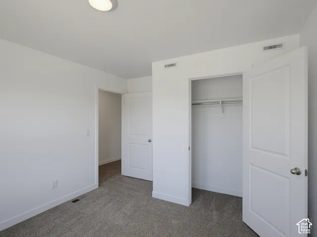 Neutral wall color, wall-to-wall carpeting, and interior panel doors