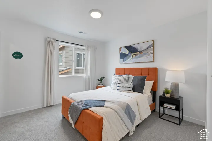 Neutral-toned carpeted flooring, white walls, and a recessed ceiling light fixture