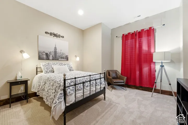 Bedroom featuring neutral wall paint, recessed lighting, wall-mounted light fixtures, and wall-to-wall carpeting