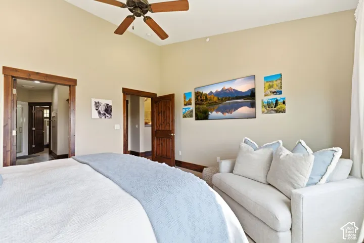 Vaulted ceilings, stained wood door trim, solid wood doors, and a ceiling fan