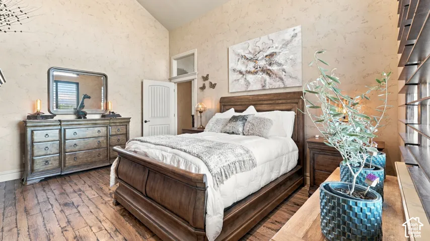 Vaulted ceilings, textured wall finish, wood-finish flooring, and transom window detail