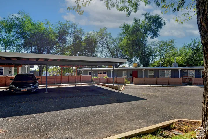 Covered parking structure, paved surface, and perimeter masonry fencing
