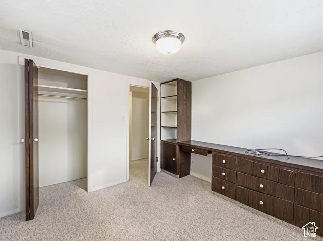 Built-in desk with shelving and integrated drawers, carpeted flooring - 4th bedroom