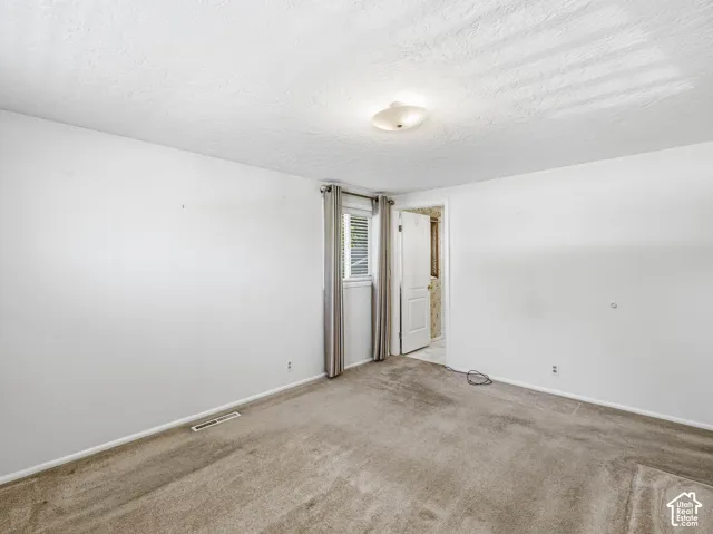 White-painted walls and a ceiling-mounted light fixture illuminate the room