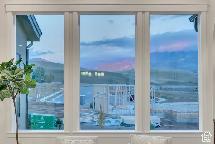 Triple-pane window configuration with white casing and expansive mountain backdrop