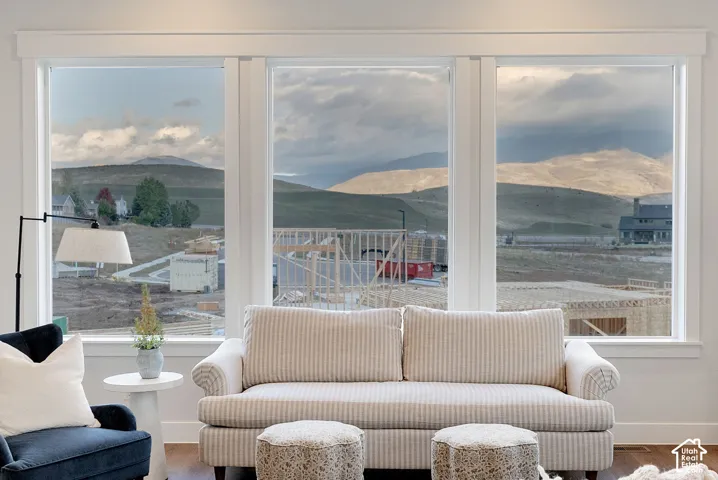 Expansive three-panel window configuration with thick white casing and mountainous landscape backdrop