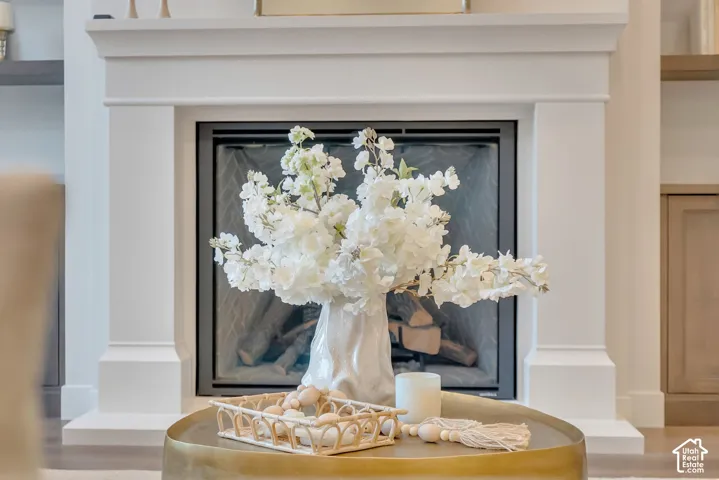 Custom fireplace mantle with clean lines, dark metal firebox insert, and built-in side cabinetry