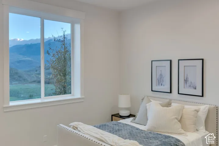 Sliding window with white casing and mountain scenery