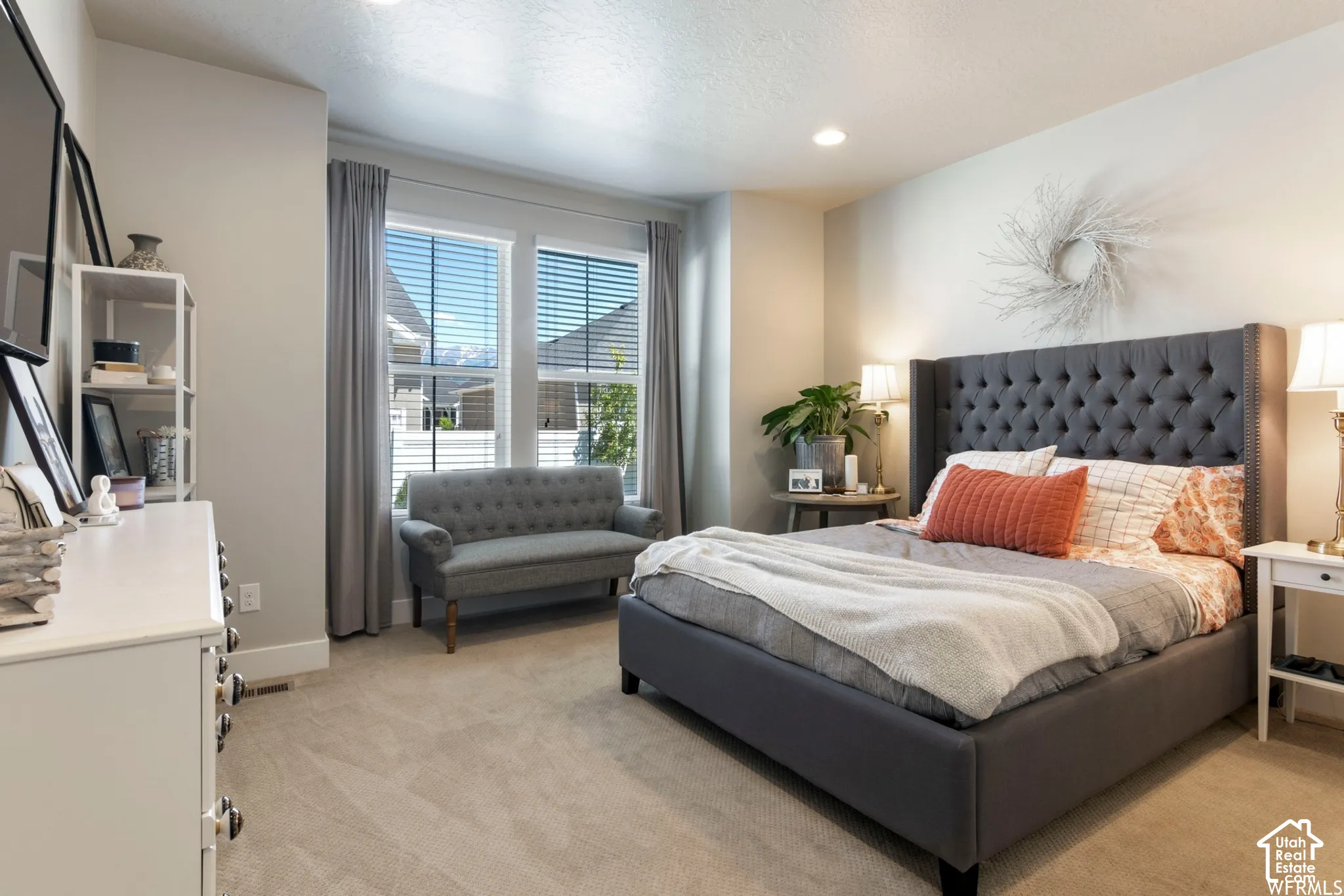 Neutral-toned interior space featuring high ceilings with recessed lighting, carpeting, and dual-pane windows