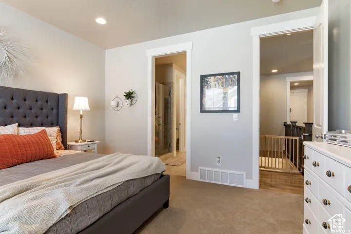 Neutral-toned carpeted flooring, recessed lighting, and crisp white door casings
