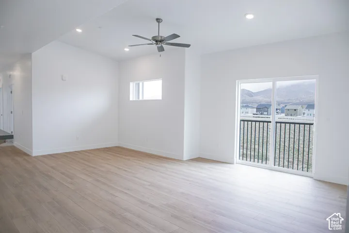 Family room with 9' ceiling, ceiling fan and sliding glass door to balcony.