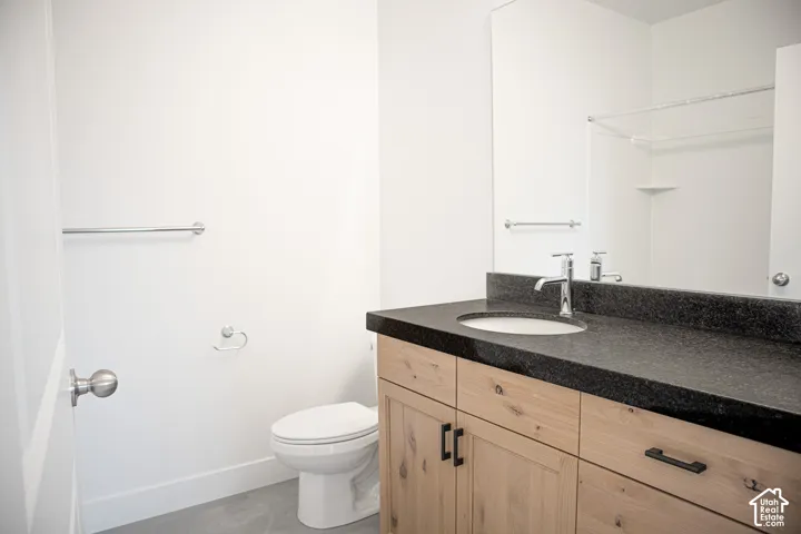 Full secondary bath with extended vanity, stained wood cabinets and granite slab countertops.