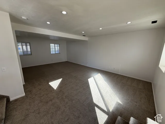 Open-concept interior featuring neutral wall tones, recessed lighting, and wall-to-wall carpeting