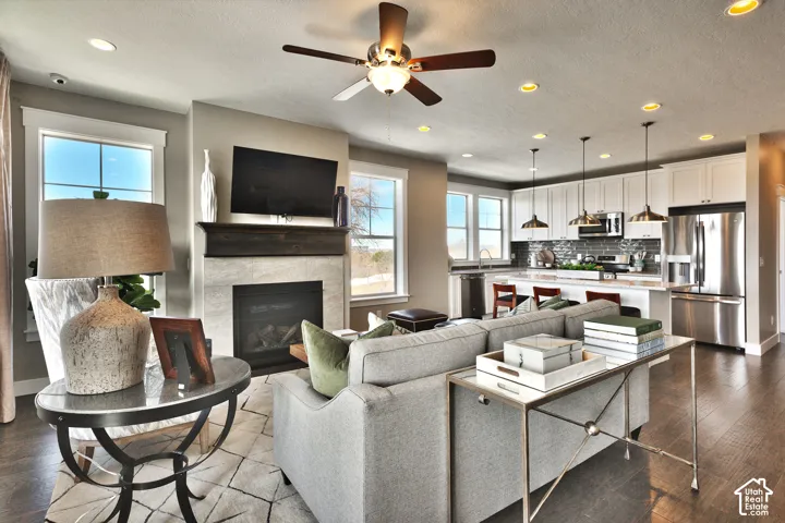Open floor plan featuring wood-finish flooring, recessed lighting, and a kitchen island with pendant lighting