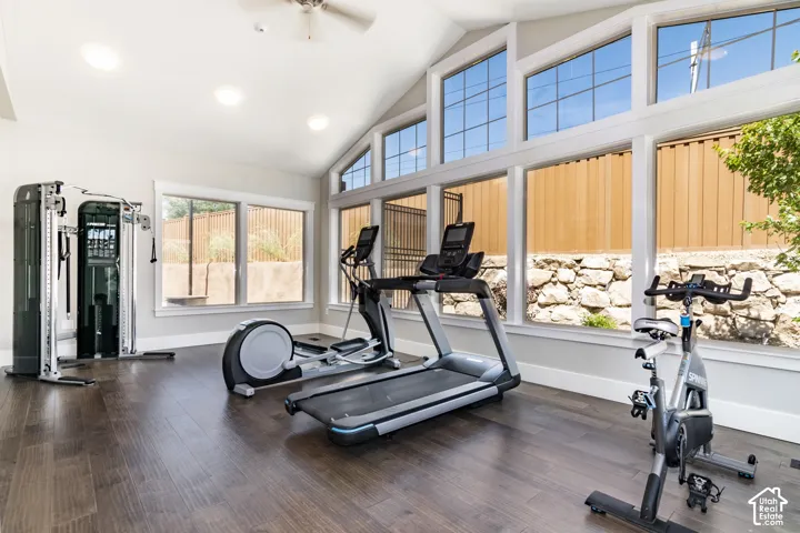 Vaulted ceiling featuring recessed lighting, expansive multi-pane window arrays, and wood-finish flooring