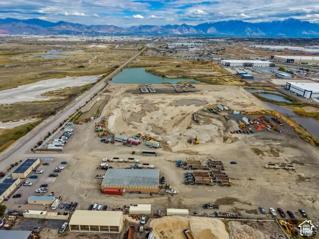 Expansive land parcel featuring prominent mountain range backdrop and multiple water features