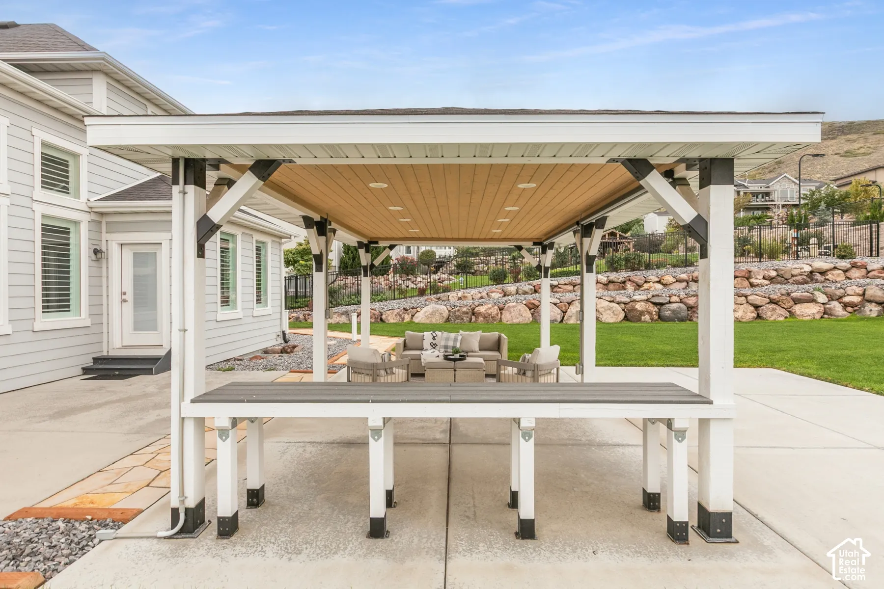 Covered outdoor structure featuring a wood-finish ceiling, recessed lighting, and a built-in counter, situated on a concrete patio